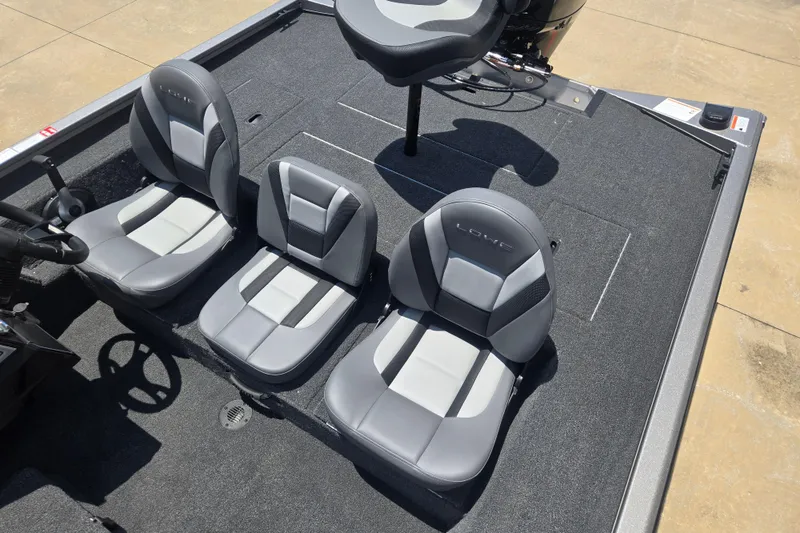 Slide: The Image of 2026 Lowe Stinger 195C boat interior with three gray seats and steering wheel. - 9