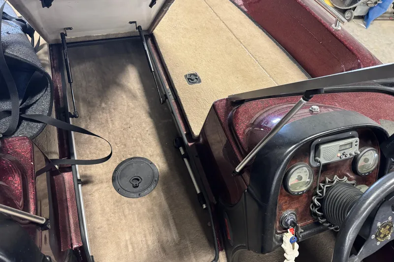 Slide: The Image of Interior of a 2000 Ranger 620VS Fisherman boat showing dashboard and storage area. - 14