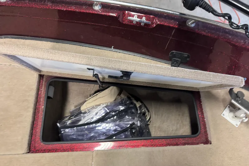 Slide: The Image of Open storage compartment in a 2000 Ranger 620VS Fisherman boat, showing interior contents. - 18