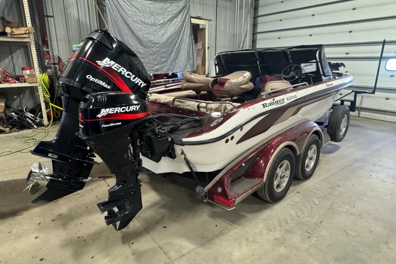 Slide: The Image of 2000 Ranger 620VS Fisherman boat with dual Mercury engines in a garage setting. - 3