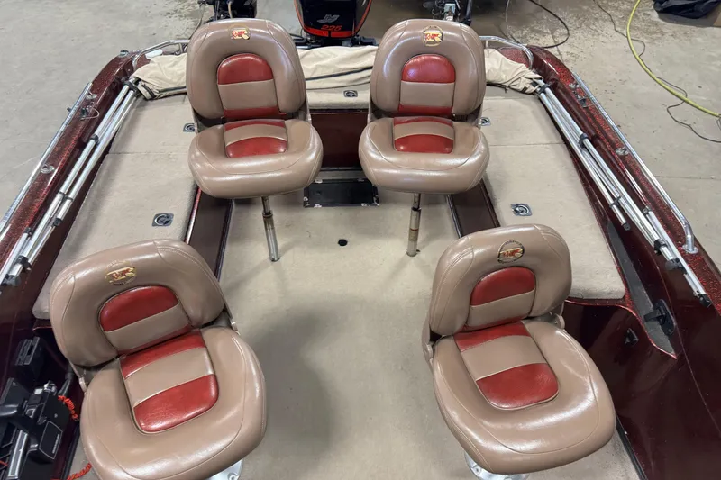 Slide: The Image of 2000 Ranger 620VS Fisherman boat interior with four tan and red seats. - 6