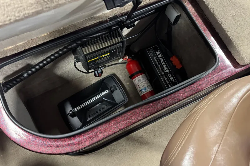 Slide: The Image of Storage compartment in a 2000 Ranger 620VS Fisherman boat with electronics and fire extinguisher. - 7