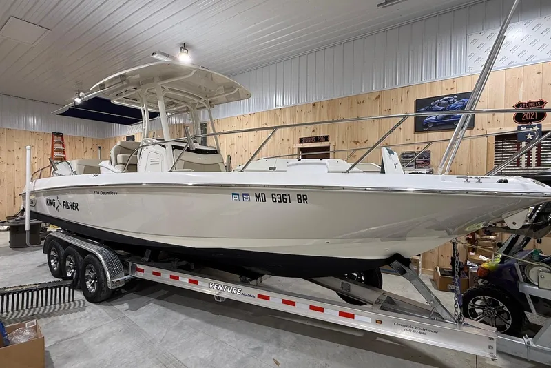 The Image of 2022 Boston Whaler 270 Dauntless boat on trailer in a garage setting. - 0