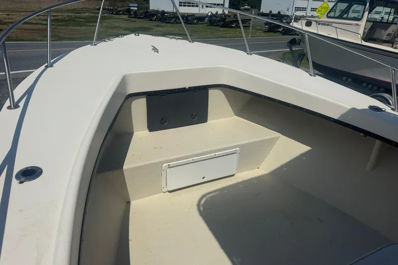 Slide: The Image of Bow area of a 1999 May-Craft 2500 boat with seating and storage. - 11