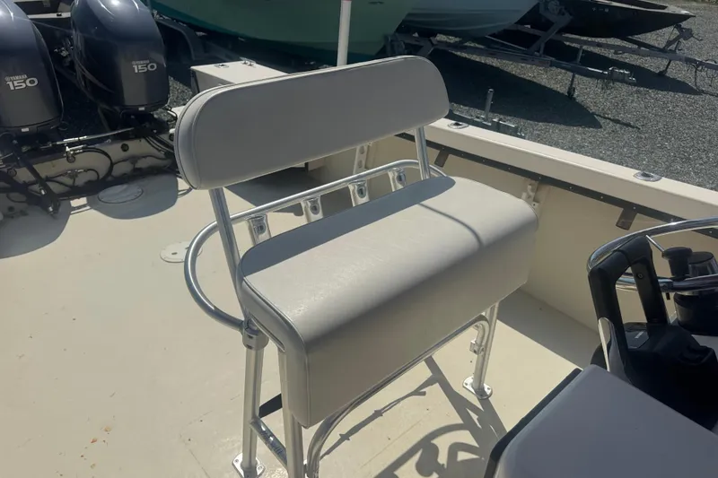 Slide: The Image of 1999 May-Craft 2500 boat interior with dual Yamaha 150 engines and cushioned seating. - 15