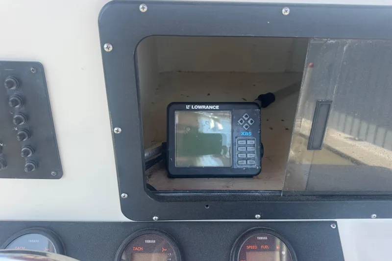 Slide: The Image of Lowrance X85 fishfinder on 1999 May-Craft 2500 boat dashboard with Yamaha gauges. - 7