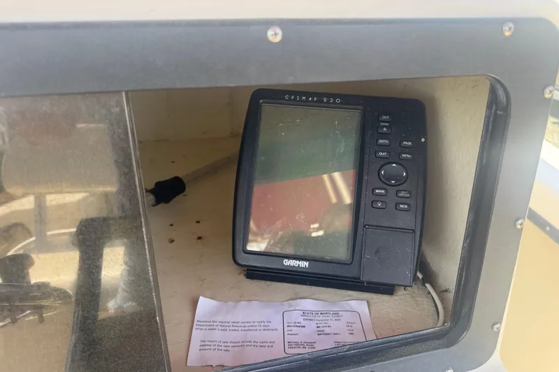 Slide: The Image of Garmin GPS device inside a 1999 May-Craft 2500 boat compartment. - 8