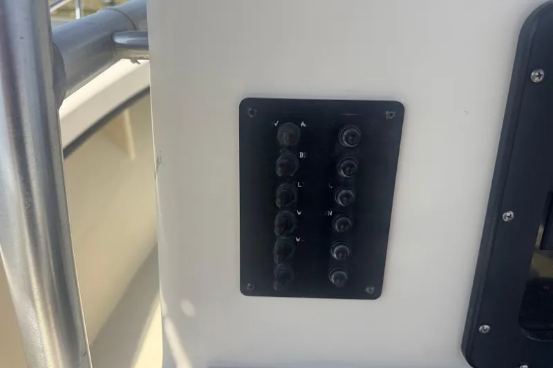 Slide: The Image of Control panel on a 1999 May-Craft 2500 boat, featuring multiple switches. - 9
