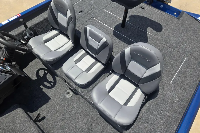 Slide: The Image of 2026 Lowe Stinger 175C boat interior with three gray seats and steering wheel. - 9