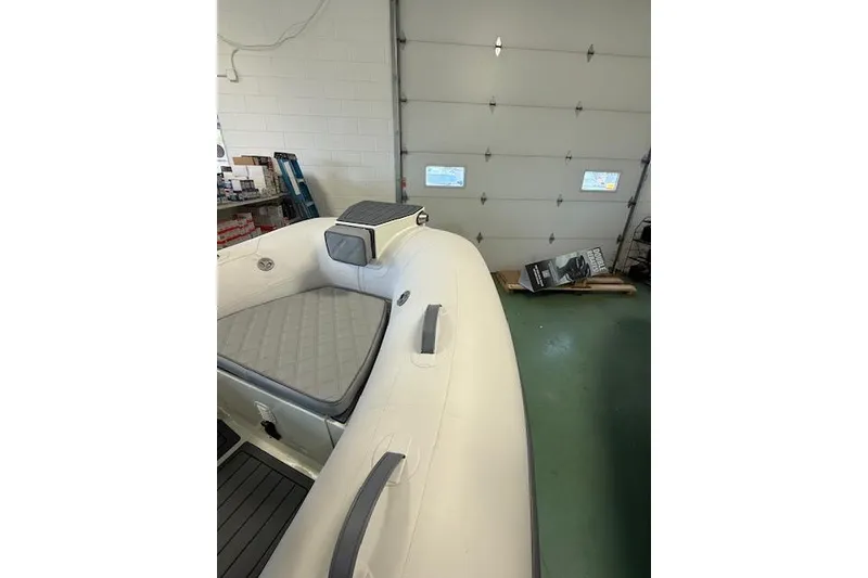 Slide: The Image of 2026 Desner Classic 310 FCT inflatable boat interior in a garage setting. - 3