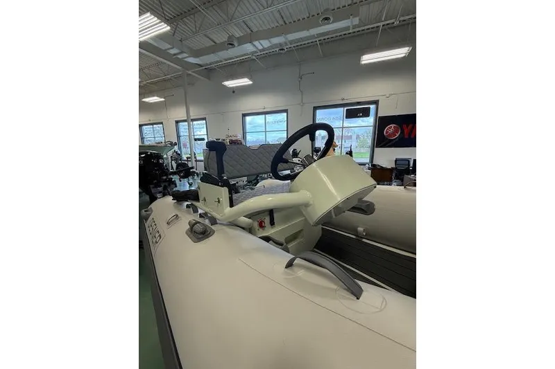 Slide: The Image of 2026 Desner Classic 310 FCT inflatable boat interior with steering wheel and seating. - 4