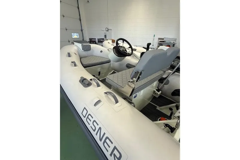 Slide: The Image of 2026 Desner Classic 310 FCT inflatable boat interior with steering wheel and seating. - 6