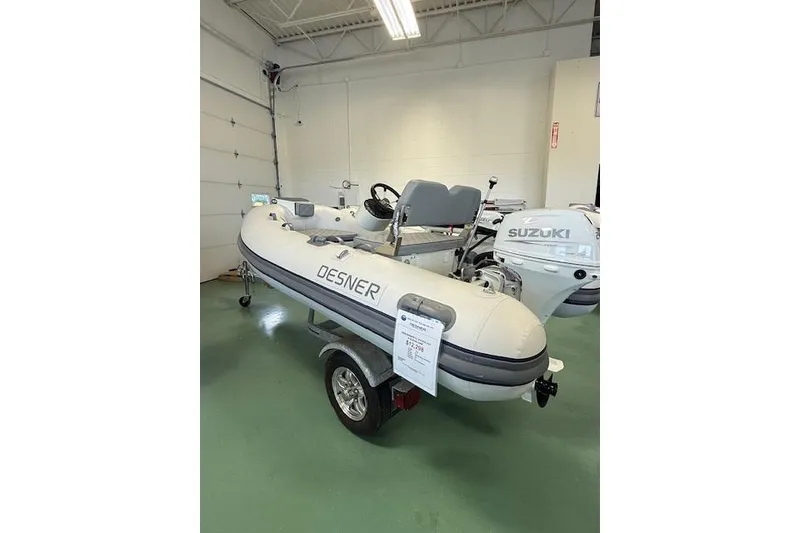 Slide: The Image of 2026 Desner Classic 310 FCT inflatable boat on trailer in showroom. - 7