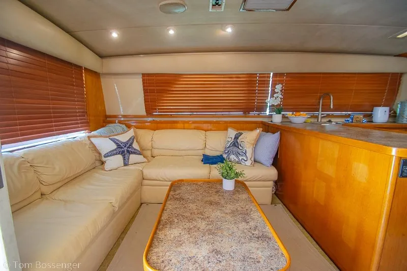 Slide: The Image of Interior of 1989 Bertram 50 Convertible yacht with cozy seating and wooden accents. - 15
