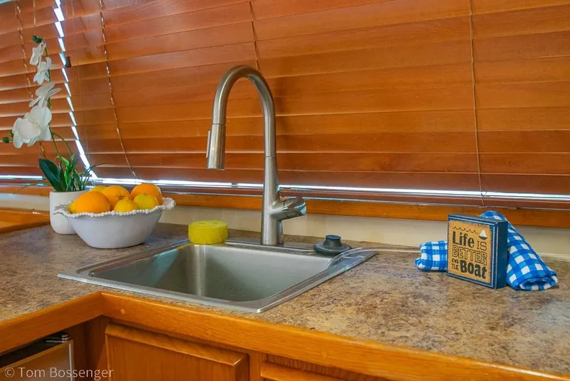 Slide: The Image of Kitchen sink area on 1989 Bertram 50 Convertible yacht with fruit bowl and decor. - 20