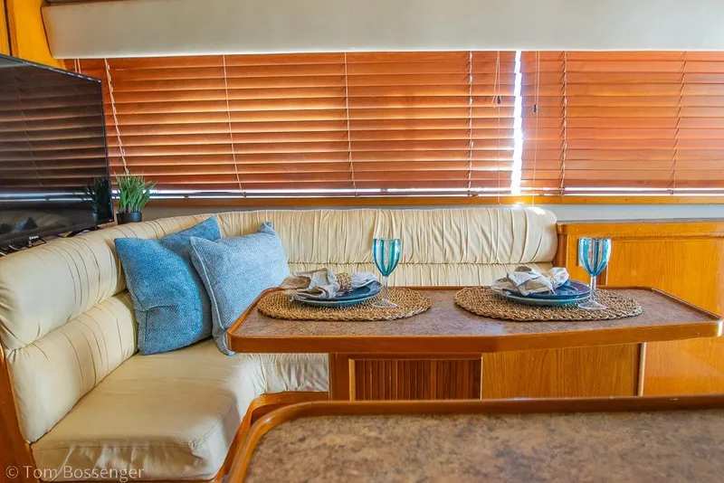 Slide: The Image of Interior of 1989 Bertram 50 Convertible yacht with elegant dining setup. - 21