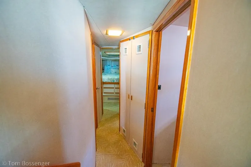 Slide: The Image of Hallway inside 1989 Bertram 50 Convertible yacht, featuring wooden doors and cozy interior. - 22