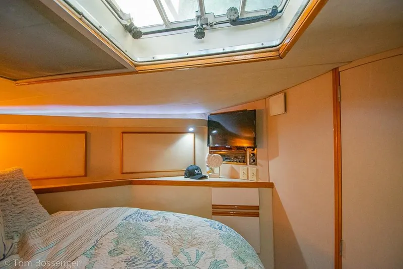 Slide: The Image of Cozy cabin interior of 1989 Bertram 50 Convertible yacht with skylight and TV. - 24