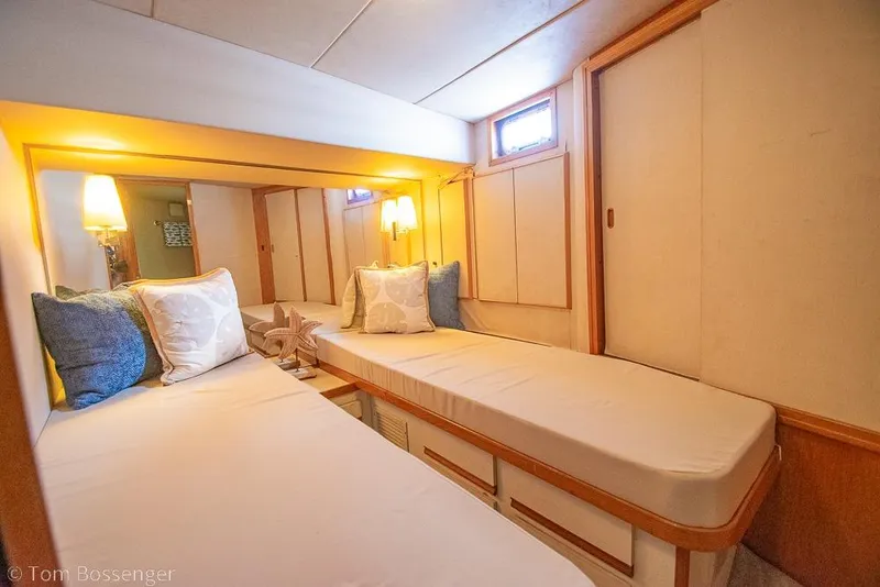 Slide: The Image of Cozy cabin interior of 1989 Bertram 50 Convertible yacht with twin beds and soft lighting. - 26