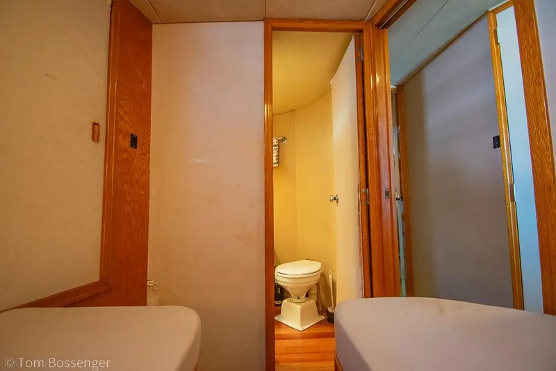 Slide: The Image of Interior of 1989 Bertram 50 Convertible yacht showing bathroom and hallway. - 27
