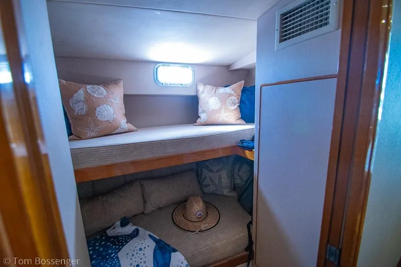 Slide: The Image of Cozy cabin interior of 1989 Bertram 50 Convertible with bunk beds and nautical decor. - 29