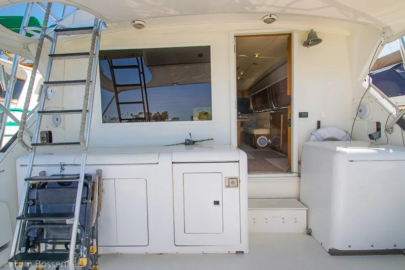 Slide: The Image of 1989 Bertram 50 Convertible yacht interior with ladder and open cabin door. - 32