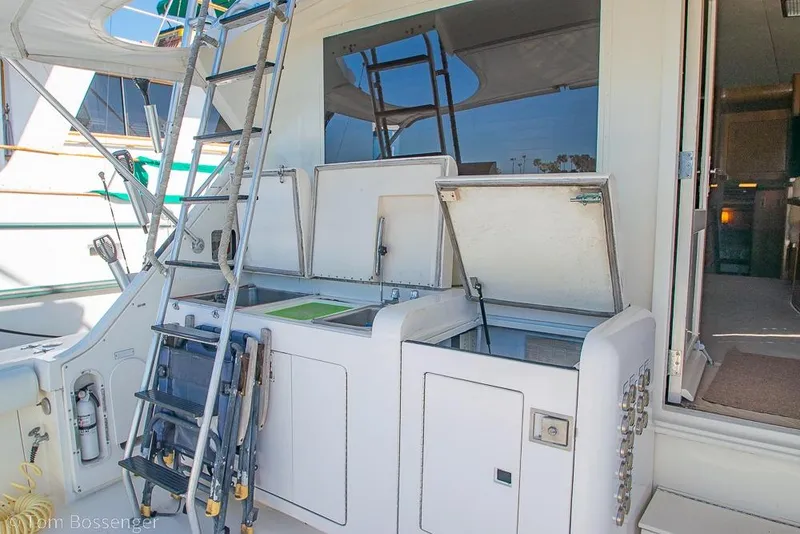 Slide: The Image of 1989 Bertram 50 Convertible yacht deck with ladder and storage compartments. - 33