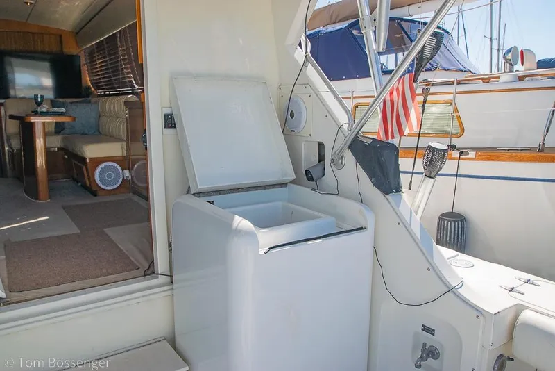 Slide: The Image of Interior view of 1989 Bertram 50 Convertible yacht with open cooler and seating area. - 34