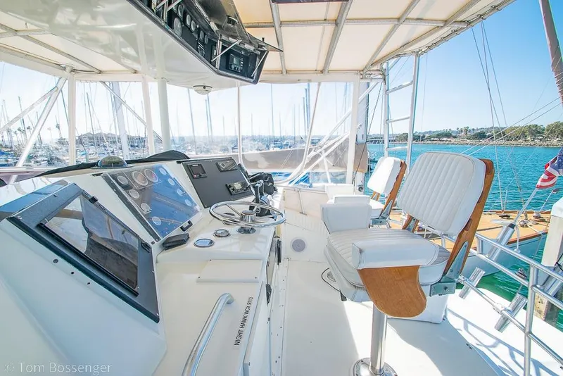 Slide: The Image of Helm of 1989 Bertram 50 Convertible yacht with dual captain chairs and navigation equipment. - 39