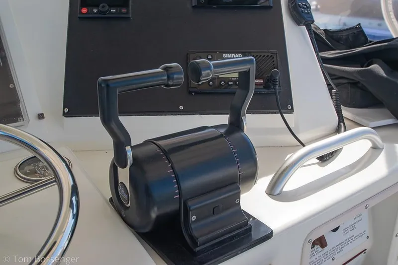 Slide: The Image of Control panel of a 1989 Bertram 50 Convertible yacht with throttle levers and navigation equipment. - 42