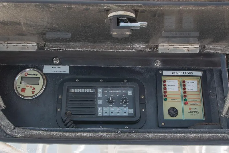 Slide: The Image of Control panel of a 1989 Bertram 50 Convertible boat with generator indicators. - 44
