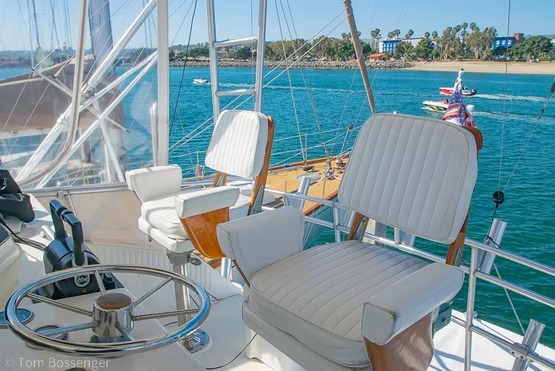Slide: The Image of Helm of 1989 Bertram 50 Convertible yacht with ocean view and plush seating. - 51
