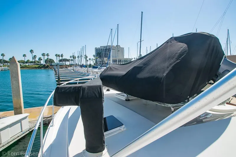 Slide: The Image of 1989 Bertram 50 Convertible yacht docked at marina with covered equipment. - 53