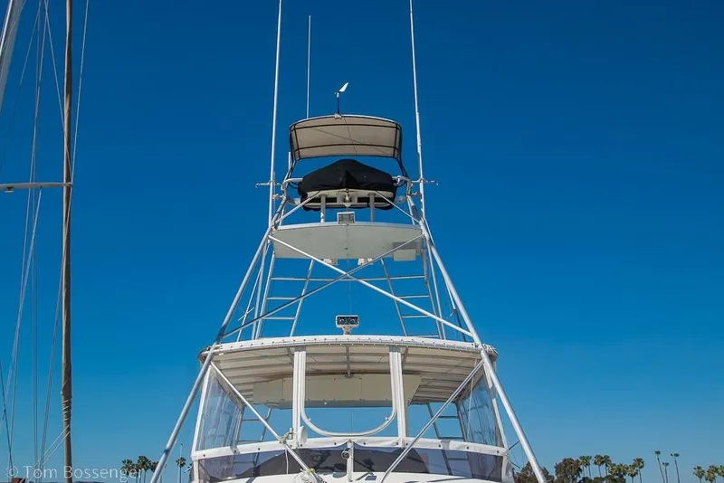 Slide: The Image of 1989 Bertram 50 Convertible yacht tower against clear blue sky. - 55