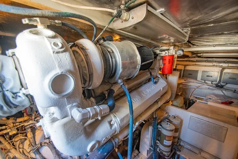 Slide: The Image of Engine room of a 1989 Bertram 50 Convertible yacht, showcasing mechanical components. - 57