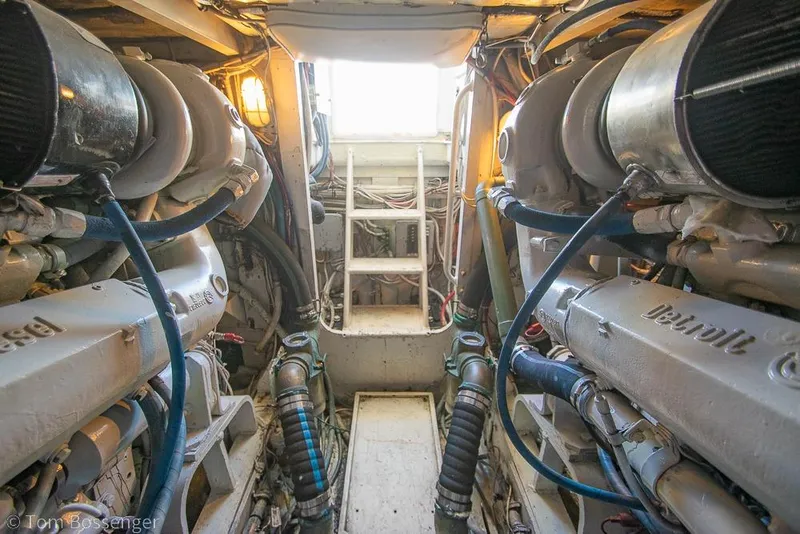 Slide: The Image of Engine room of a 1989 Bertram 50 Convertible yacht, featuring Detroit Diesel engines. - 58