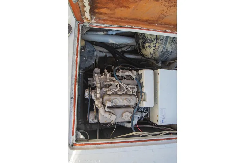 Slide: The Image of Engine compartment of a 1989 Bertram 50 Convertible boat, showing mechanical components. - 59