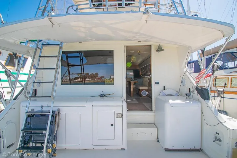 Slide: The Image of 1989 Bertram 50 Convertible yacht with open deck, ladder, and interior view. - 8
