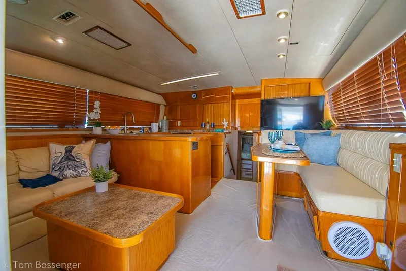 Slide: The Image of Luxurious interior of a 1989 Bertram 50 Convertible yacht with wooden finishes. - 9
