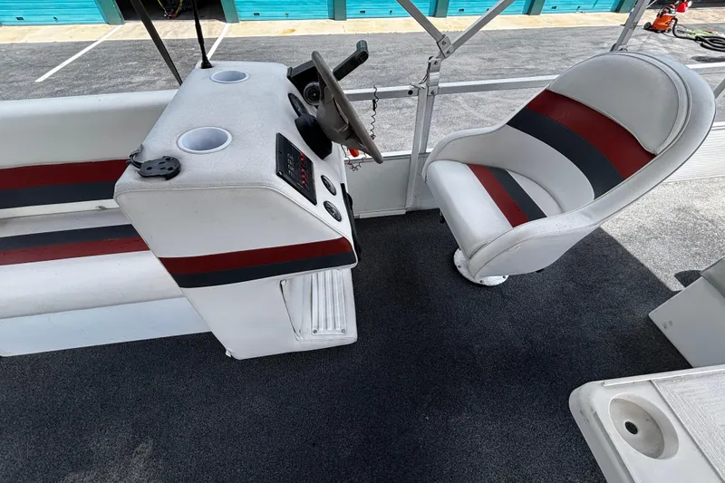 Slide: The Image of 2001 Godfrey Sweetwater 20 boat interior with steering console and seating. - 10