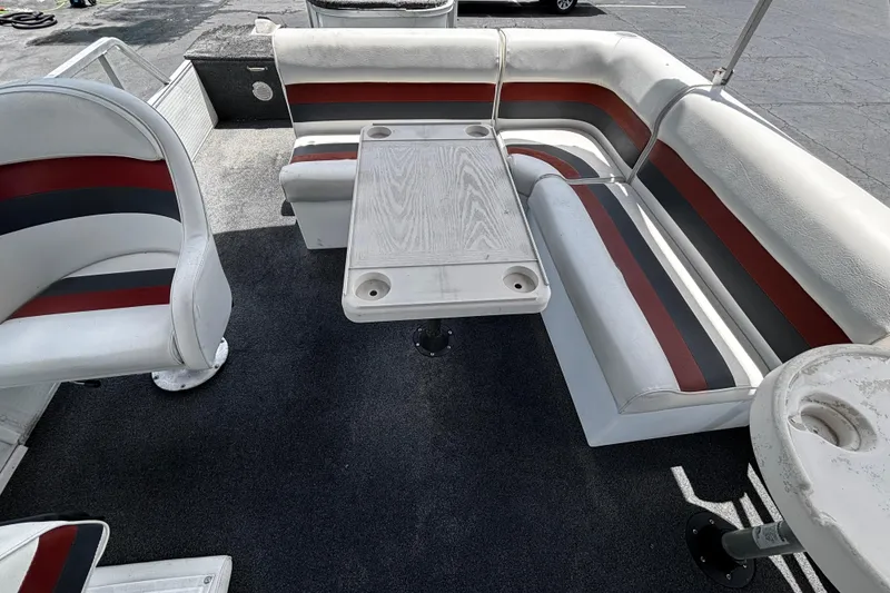 Slide: The Image of 2001 Godfrey Sweetwater 20 pontoon boat interior with seating and table. - 11