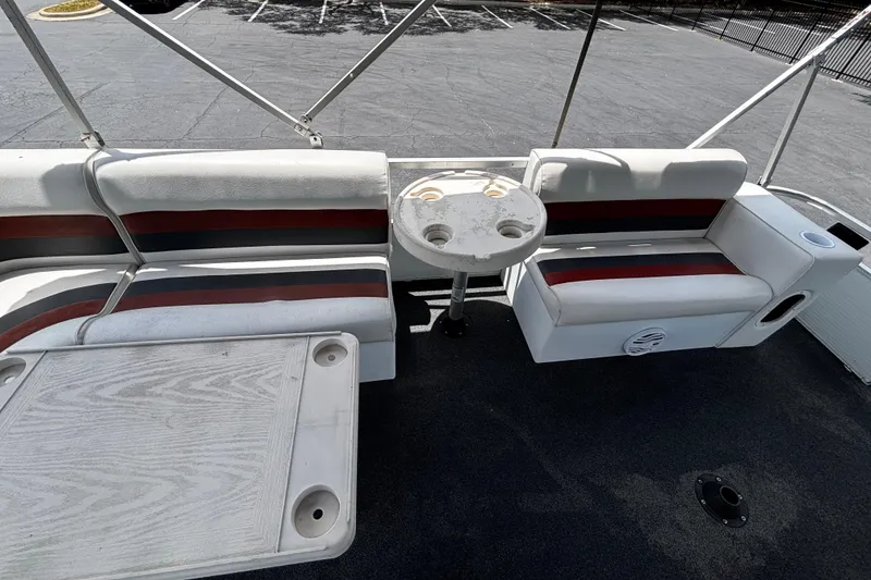 Slide: The Image of Interior of a 2001 Godfrey Sweetwater 20 pontoon boat with seating and table. - 12