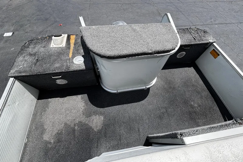 Slide: The Image of 2001 Godfrey Sweetwater 20 boat interior with carpeted flooring and storage compartments. - 14