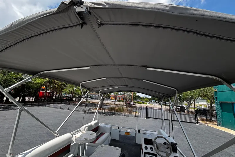 Slide: The Image of 2001 Godfrey Sweetwater 20 pontoon boat with canopy, parked in a lot. - 5