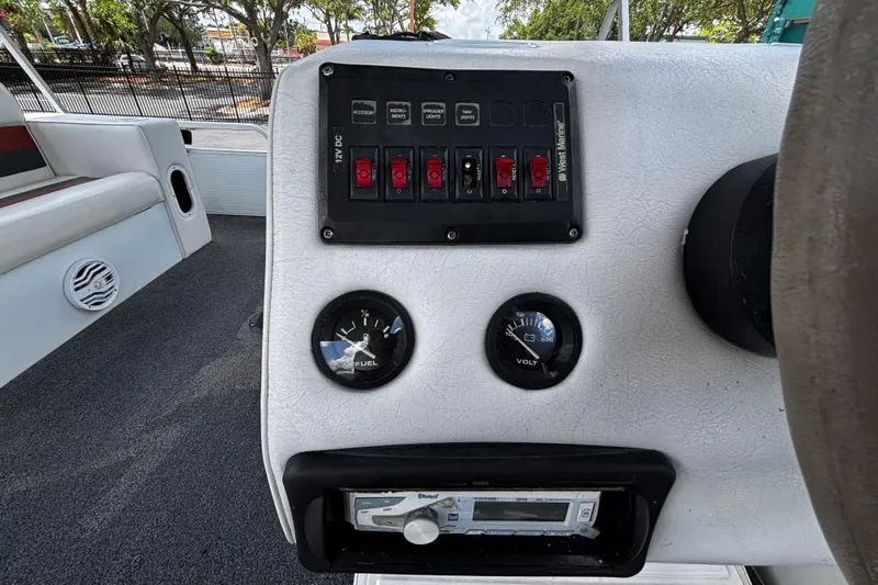 Slide: The Image of Control panel of a 2001 Godfrey Sweetwater 20 boat with gauges and switches. - 8