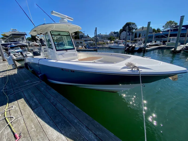 The Image of 2014 Boston Whaler 320 Outrage docked on a sunny day. - 0