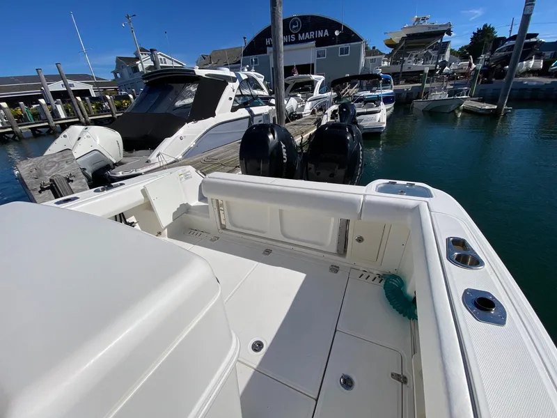 Slide: The Image of 2014 Boston Whaler 320 Outrage docked, featuring engines and marina view. - 11