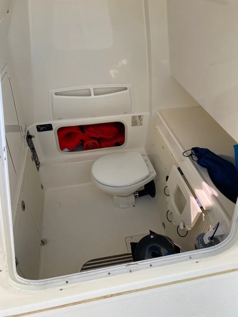 Slide: The Image of Interior of a 2014 Boston Whaler 320 Outrage with toilet. - 13