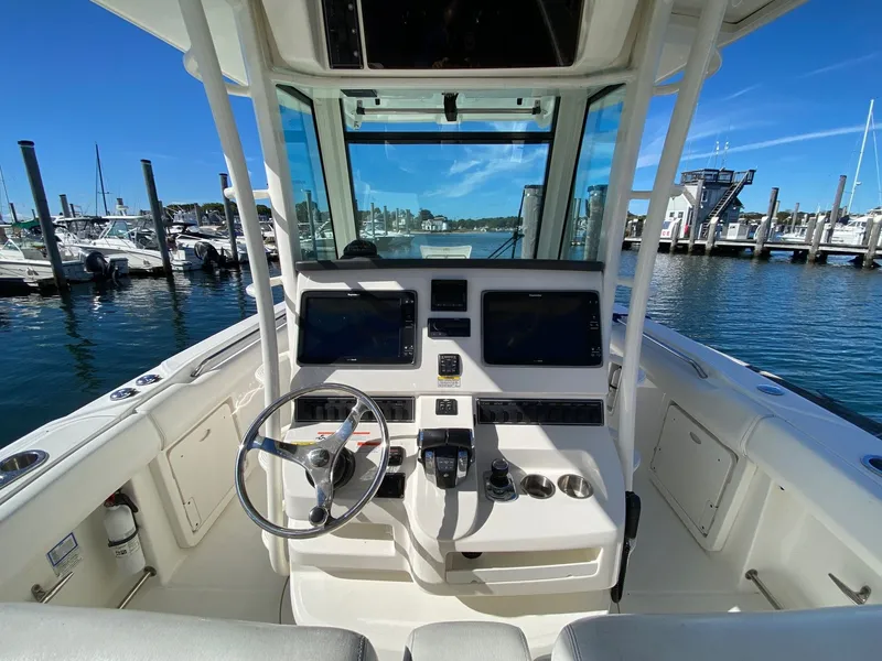 Slide: The Image of Interior view of a 2014 Boston Whaler 320 Outrage boat at the marina. - 3