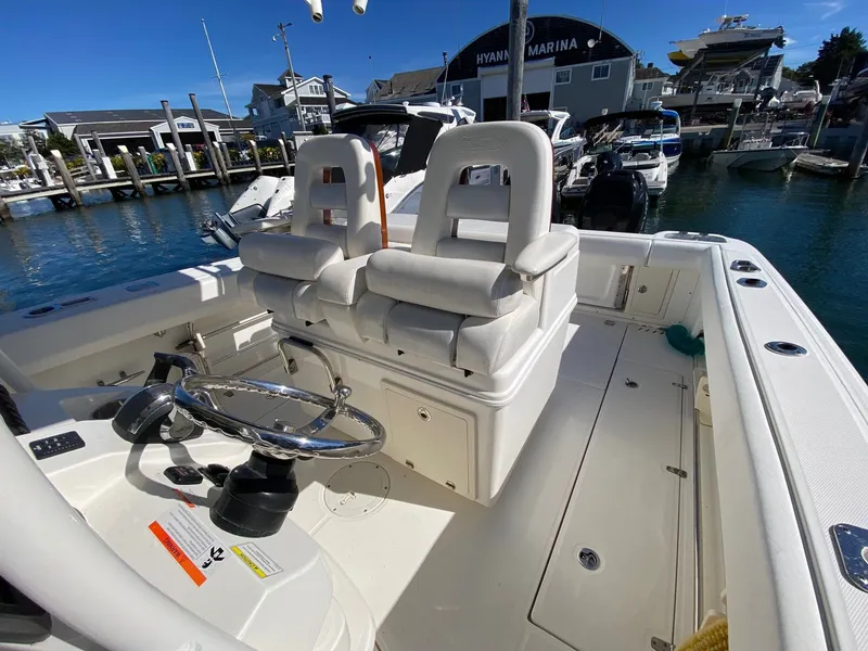 Slide: The Image of 2014 Boston Whaler 320 Outrage at marina, interior helm view. - 5